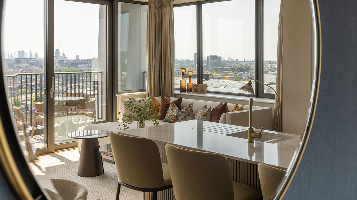 Modern apartment interior with a dining area, floor-to-ceiling windows and a furnished living space designed for comfortable residential living.
