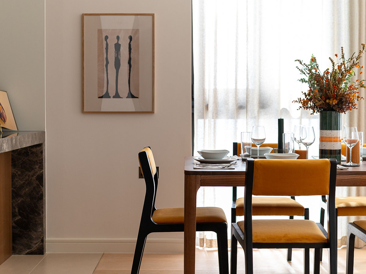 Modern dining space with styled table and artwork, reflecting interior design services in Dubai